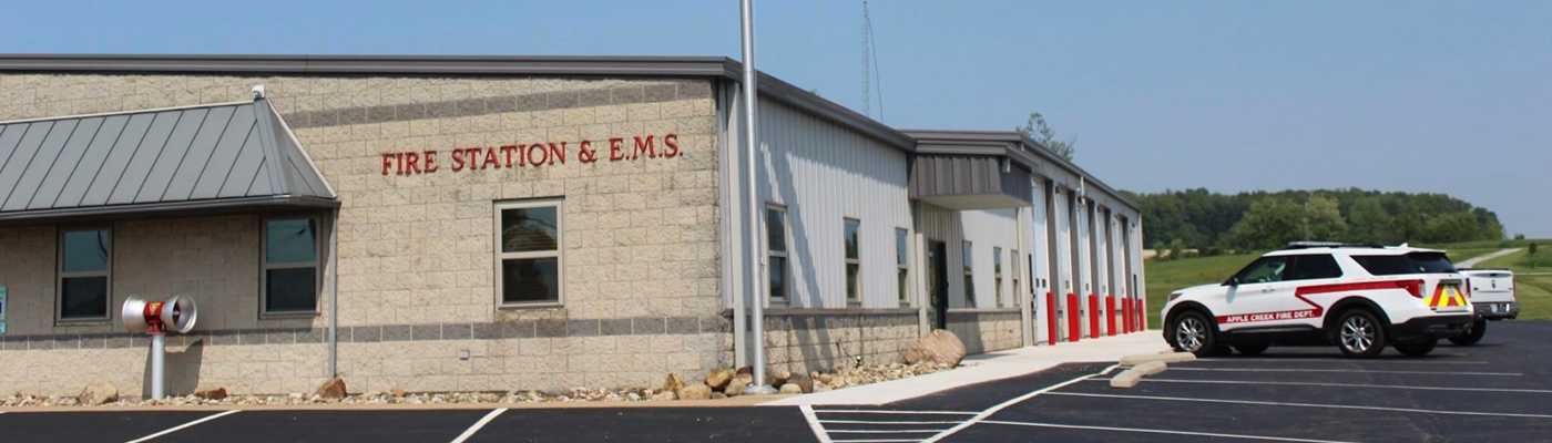 Fire Station and E.M.S. building exterior with a parked emergency vehicle.
