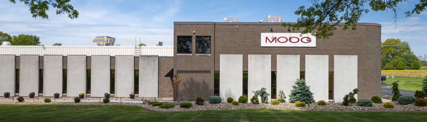 Moog corporate facility exterior with brick and concrete architecture.