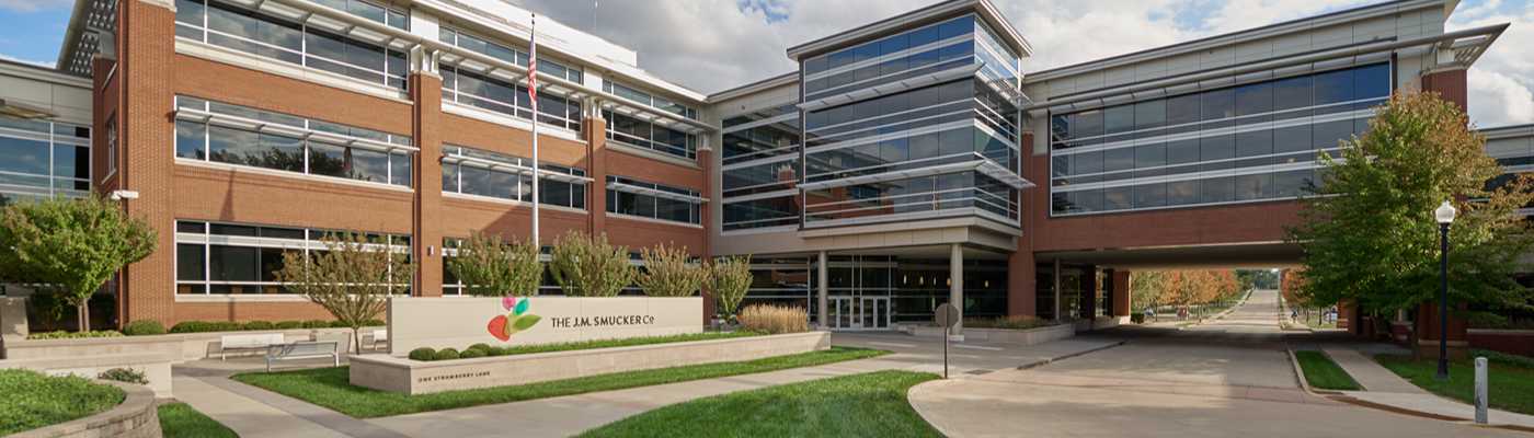 The J.M. Smucker Co. corporate headquarters with brick exterior and glass walkways.