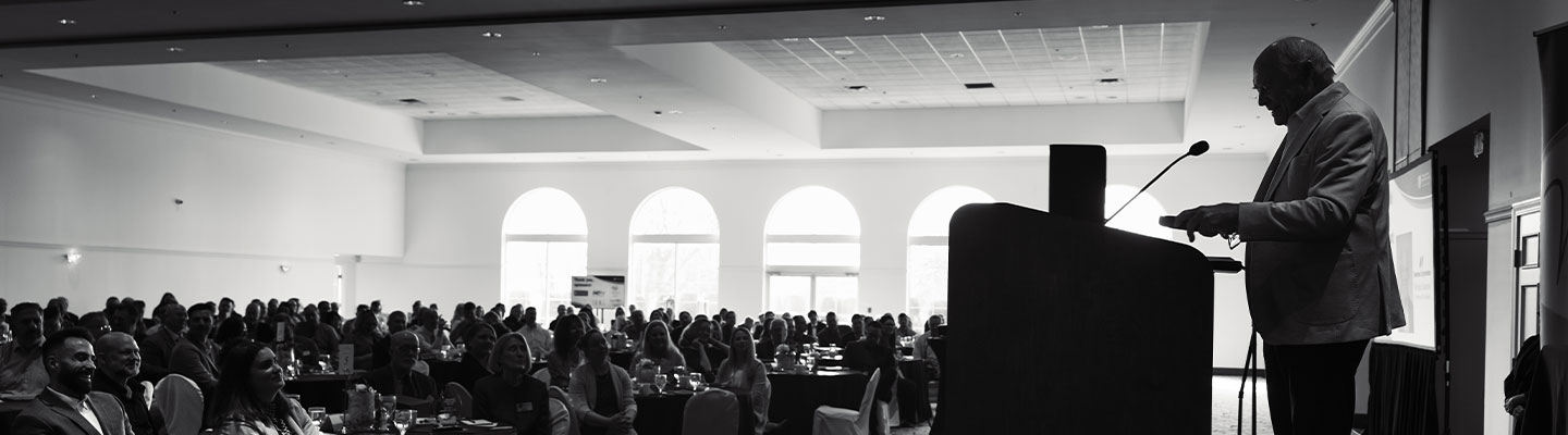 man speaking at a conference