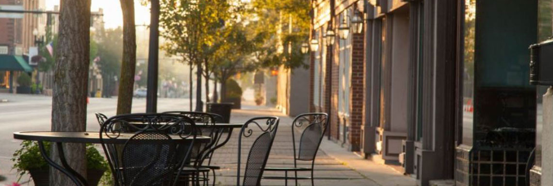 downtown sidewalk and table at sunset